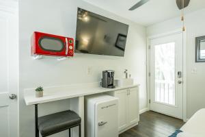 a room with a white counter with a red tv on the wall at 13 The Eero Room - A PMI Scenic City Vacation Rental in Chattanooga