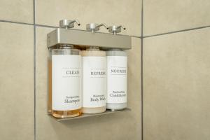 a shelf with three bottles on a wall in a bathroom at 13 The Eero Room - A PMI Scenic City Vacation Rental in Chattanooga +26 photos