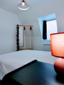 En eller flere senge i et værelse på Le Passage Secret