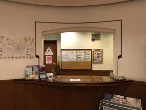 a ticket counter in a waiting room with a mirror at ＨＯＴＥＬ ＰＯＳＨ - Vacation STAY 55608v in Odawara