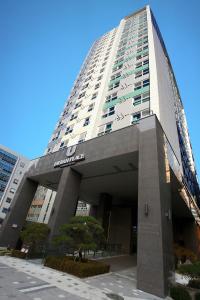 a tall building with a sign on the front of it at Urban Place Gangnam in Seoul