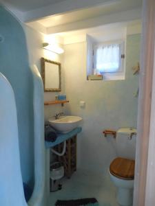 a bathroom with a sink and a toilet at Sea view houses in Kamari