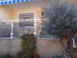 a building with flowers and plants in front of it at Amanecer marino, solo a 5 minutos andando de la playa in Puzol