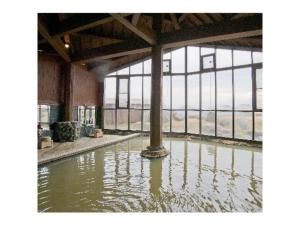 a pool of water in a building with a large window at Resonate Club Shape - Vacation STAY 60134v in Taketa +49 photos