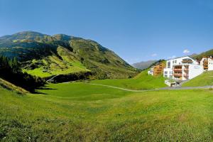 a green hill with houses and a road on it at Apartment in Obergurgl in the mountains in Obergurgl