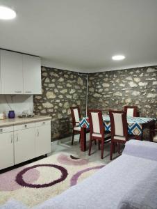 a kitchen and dining room with a table and chairs at Apartments Janiki in Kruševo