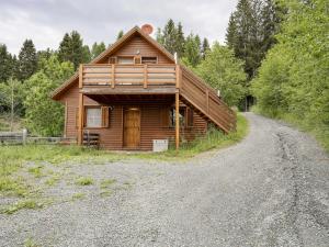 a log cabin on a dirt road at Detached wooden chalet in Liebenfels Carinthia near the Simonh he ski area in Liebenfels