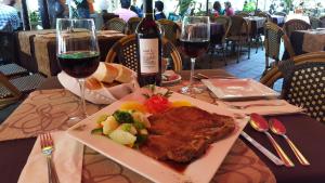 a plate of food on a table with a bottle of wine at Hotel Posada Santa Fe in Guanajuato
