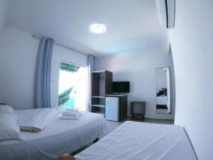 Postel nebo postele na pokoji v ubytování Hotel Pousada Oasis + 35 fotografií