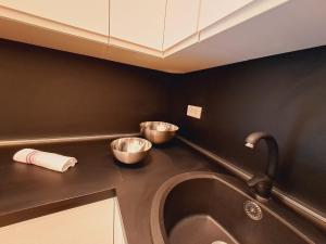 a kitchen with two metal bowls on a counter at La dimora dei Rolli in Genoa