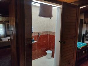 a bathroom with a shower and a toilet in a room at Tu Casa - Hotel Rural in Sopó