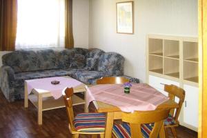 a living room with a table and a couch at Apartment in St Kanzian 800 m from the lake in Srejach