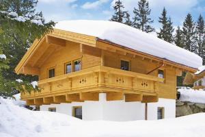 a log home with snow on the roof at Chalet, Hochkrimml in Krimml