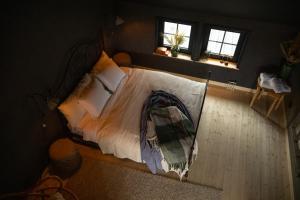 a bedroom with a bed with a blanket on it at Boutiquehotell Dahlbogården in Alingsås