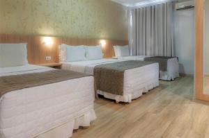 Postel nebo postele na pokoji v ubytování Hotel Rafain Centro