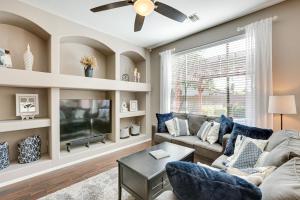 a living room with a couch and a tv at Sunny Arizona Getaway with Heated Pool and Patio! in Surprise