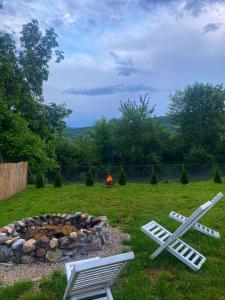 two lawn chairs sitting next to a fire pit at Brvnara Riva in Niš