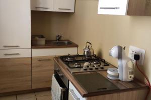 a kitchen with a stove and a counter with a mixer at Home away from Home in Żurrieq