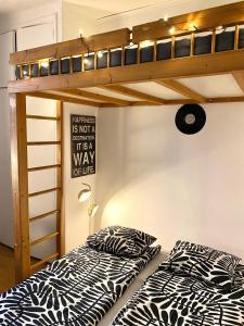 two beds in a room with a bunk bed at Cozy nest in the heart of Helsinki in Helsinki