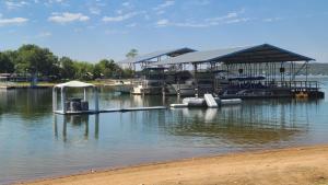 a dock with a pavilion on a body of water at Willow Beach RV Park & Marina in Graford