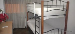 a couple of bunk beds in a room at Habitaciones individuales en apartamento turístico in Madrid