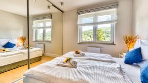 Ένα ή περισσότερα κρεβάτια σε δωμάτιο στο Apartament BlueSky - 5D Apartamenty
