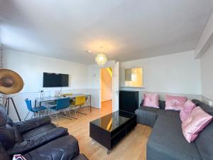 a living room with a couch and a table at 36 O’Leary square in London