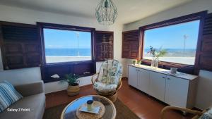 a living room with a view of the ocean at Villa Salada on the Ocean Shore in Caleta De Fuste