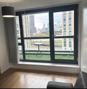 a room with a large window with a view of a city at 2 bed apartment close to station with parking in London