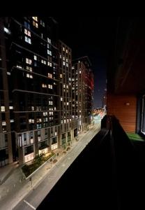 a view of a city street at night with tall buildings at 2 bed apartment close to station with parking in London