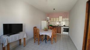 a kitchen with a table and chairs and a television at EcoNina in Salta