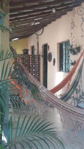 a hammock on the side of a building at Casa temporada maricá in Maricá