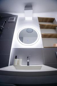 a bathroom with a sink with a light above it at Apartament 209 in Alba Iulia