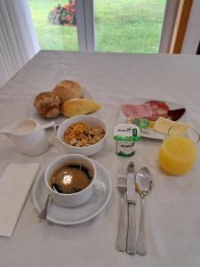 a breakfast table with a cup of coffee and a plate of food at CasaAnabela in Póvoa de Varzim