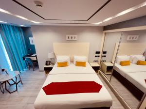 a hotel room with two beds and a mirror at Petra Boutique Hotel in Wadi Musa +134 photos