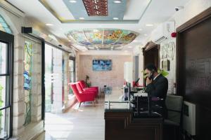 a man talking on a cell phone in a salon at Petra Boutique Hotel in Wadi Musa