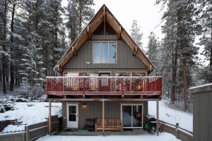 a house with a deck in the snow at Leavenworth Mountain View Cabin w/ Space to Hike in Leavenworth