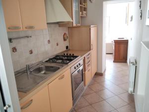 a kitchen with a sink and a stove top oven at Casa Artisti in Carrara
