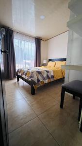 1 dormitorio con cama y ventana en Senderos Apartment, Self Check- in, Airport SJO 5 MIN en Santiago Este