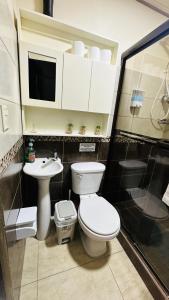 a bathroom with a toilet and a sink at Senderos Apartment, Self Check- in, Airport SJO 5 MIN in Santiago Este