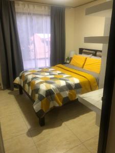 a bedroom with two beds and a window at Senderos Apartment, Self Check- in, Airport SJO 5 MIN in Santiago Este