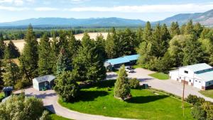 an aerial view of a park with a building and trees at Glacier's Edge Cabins in Columbia Falls