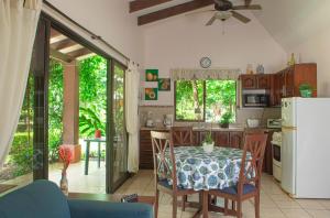 a kitchen with a table and a refrigerator at Apartments-Villas Playa Potrero 1 in Potrero
