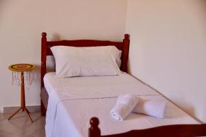 a bed with two towels on it in a room at Shpija E AMEL (Sweet Guest House) 