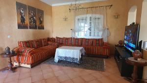 sala de estar con sofá y TV en Lara House 1, en Agadir