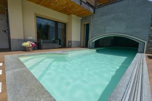 a swimming pool in a house with a stone wall at Casa Sogno in Aosta