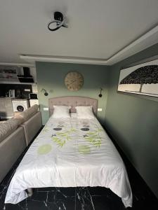 a bedroom with a bed and a couch at Sweet home in Bagnolet