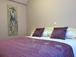a bedroom with a bed with a purple blanket at Apartments Sanbrandin in Krk