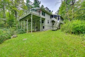 een huis met een grote tuin in het bos bij Spacious Tolland Home with Deck and Screened Porch! in Sandisfield