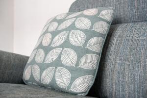 a pillow on a couch with a pattern on it at Alston House in Hartlepool